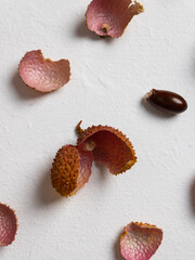 Peel of fresh lychee on a white background diagonally. Food pattern