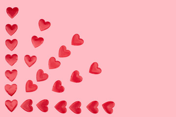 red hearts on a pink pastel background. Abstract background with paper-cut shapes. Sainte Valentine, mother's day, birthday greeting cards, invitation, celebration concept