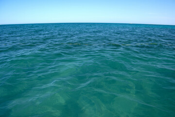 Closeup seascape surface of blue sea water with small ripple waves