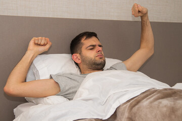 yawning man waking up in bed