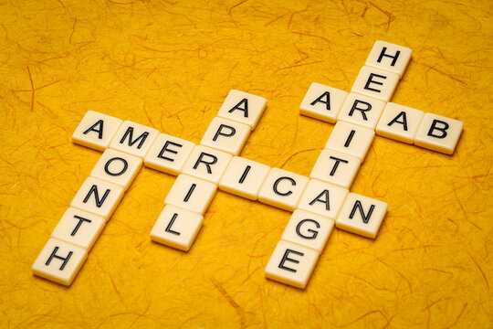 April - Arab American Heritage Month, crossword in ivory letter tiles against textured handmade paper