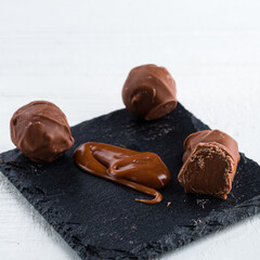 Melted caramel candies and caramel sauce with a salt on a white background. Close up