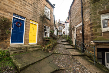 Robin Hood's Bay, Yorkshire, United Kingdom - December 05 2022: A charming street built of stone in the village of Robin Hood Bay.