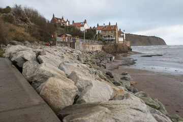 Robin Hood's Bay, Yorkshire, United Kingdom - December 05 2022: A breakwater made of huge boulders located along the coast.