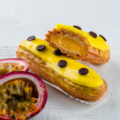 Beautiful and tasty eclair with yellow glaze and mango-passion fruit flavor