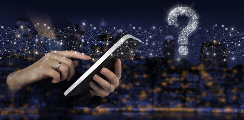 Business support concept. Problems and solutions. Hand touch white tablet with digital hologram question mark sign on city dark blurred background. FAQ frequently asked questions concept.