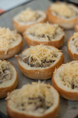 buns stuffed with mushrooms and cheese on a baking sheet