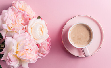 Morning cup of coffee and beautiful flowers on pink background