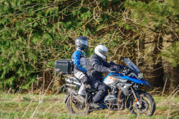 motorbike rider and pillion passenger on a BMW R1200 GS motorcycle travelling through winter...