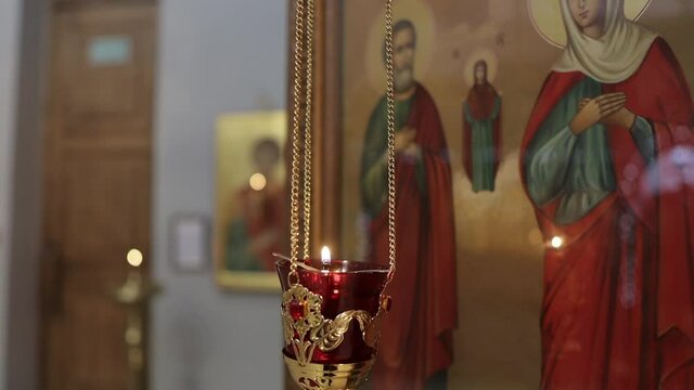 a lamp in front of an icon in an Orthodox church.