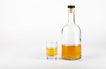 Glass and bottle of alcohol on a white background.Concept of alcoholism.