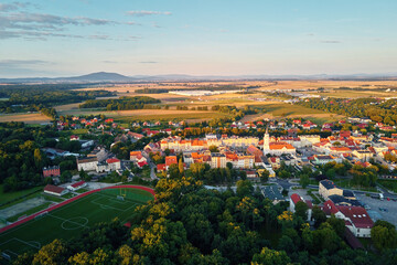 Aerial view of small european town with sradium and sport field