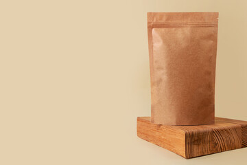 Pouch bag mockup wooden podium neutral beige background monochrome. Merchandise packaging Blank brown kraft paper pack coffee beans product template copy space. Tea food snack delivery Shop store sale