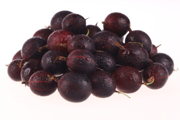 heap of red gooseberries isolated on white
