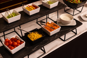 The salad buffet bar at the restaurant with lots of vegetables dishes.