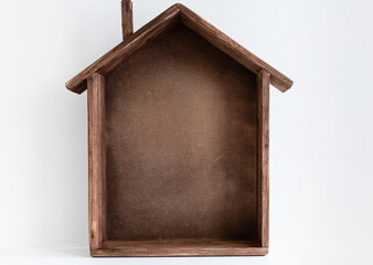 Small toy wooden handmade house on white background