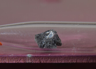 Microphoto of a sample of the periodic elementt No. 33: Arsenic. The toxic metal is stored in a glass ampoule