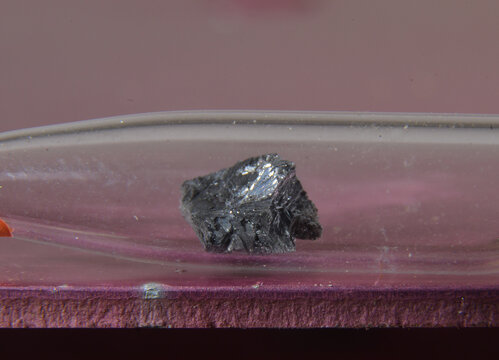 Microphoto of a sample of the periodic elementt No. 33: Arsenic. The toxic metal is stored in a glass ampoule