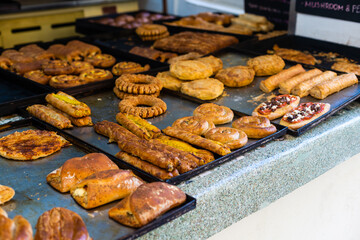 typical Greek sweet street baked goods in a storefront of a Greek pastry.