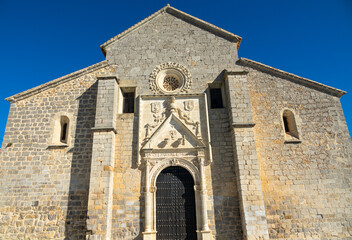 Fototapeta na wymiar View of the Santa Maria la Mayor church in Alcaudete (Spain) on a sunny winter morning