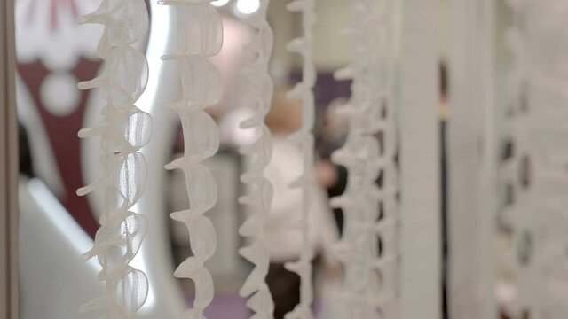 New samples of tape for window curtains are hang with each other for better comparison and selection of the suitable. Shot in motion. Closeup