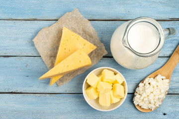 dairy products, cheese, butter, cottage cheese, milk on a blue wooden table