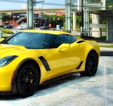 Detroit, Michigan, US - July 3, 2015: The new model Chevy Corvette Z06 on display at outside of the GM riverfront buildings, Detroit, Michigan. Beautiful yellow luxury car.