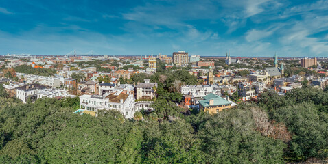 Aerial view of Savannah historic district in Georgia during daylight with a few high rise buildings, from FOrsyth park looking at the historic buildings - obrazy, fototapety, plakaty