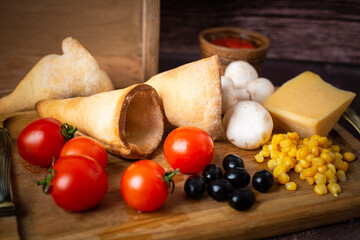 pizza cone ingredients, delicious pizza horns with a crispy thin crust, lots of melted cheese
