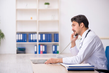 Young male doctor in telemedicine concept