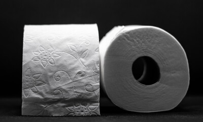 Two rolls of toilet paper isolated with black background