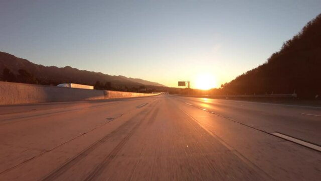 Empty freeway sunrise driving on 210 east in the Tujunga area of Los Angeles, California.