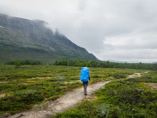 hiker walking in the mountains in northern sweden