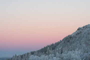 pale pink sunrise in the mountains in northern sweden