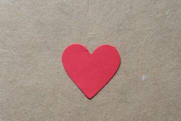 torn paper heart on cardboard