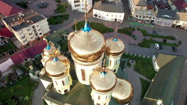 The Christian church at sunset, aerial view. A majestic Christian cathedral with large golden domes and crosses. Temple in the Transcarpathian city of Khust, Ukraine. St. Cyril and Methodius Cathedral
