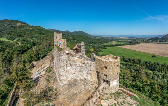 Aerial view of Reviste castle above the Hron river with partially restored gate tower, palace walls and donjon