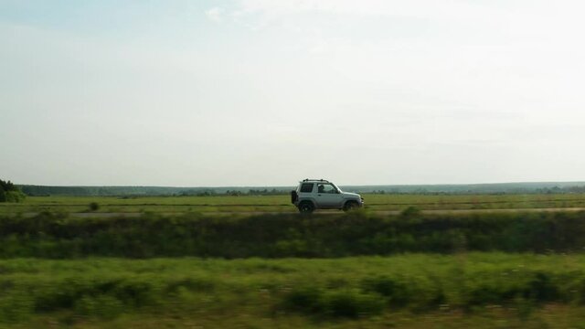 Aerial view of a car driving on a country road