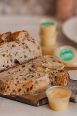 Ghee butter in glass jar and sliced bread on table. Healthy eating, breakfast