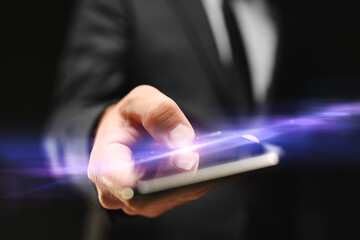 Businessman using mobile smartphone, closeup of hand tapping the touchscreen with thumb
