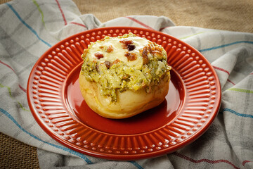 Baked potato with cheese and broccoli bacon food, red plate