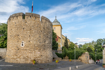Summer view of the barbakan of Pecs, medieval circular defensive gate tower with loopholes, draw ridge, moat protecting the town from Turkish invasion  - obrazy, fototapety, plakaty