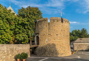 Summer view of the barbakan of Pecs, medieval circular defensive gate tower with loopholes, draw ridge, moat protecting the town from Turkish invasion  - obrazy, fototapety, plakaty
