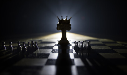 chess board game concept of business ideas and competition and strategy ideas concep. Chess figures on a dark background with smoke and fog and window with sunlight. Selective focus