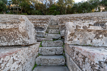 Close up of limestone stairs and seats at the ancient Theater at Epidaurus a 4th century BC Greek site, part of the Asklepieion, a healing center in ancient Greece.