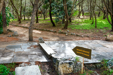 A sign point the way to the prison cave of the Greek philosopher Socrates on Philopappos or...