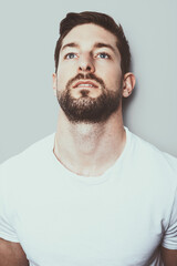 Obraz premium Man in white shirt look up while being in thoughts and think about his depressions, memories and bad decisions