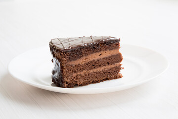 Chocolate cakeclose-up is on a white plate. - 479445263