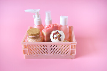  rose extract cosmetics.Bath bombs with rose petals,Pink cosmetic bottles in a pink box close-up on...