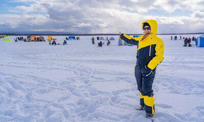 Happy woman on the ice of the sea.Active vacation.Winter fishing.